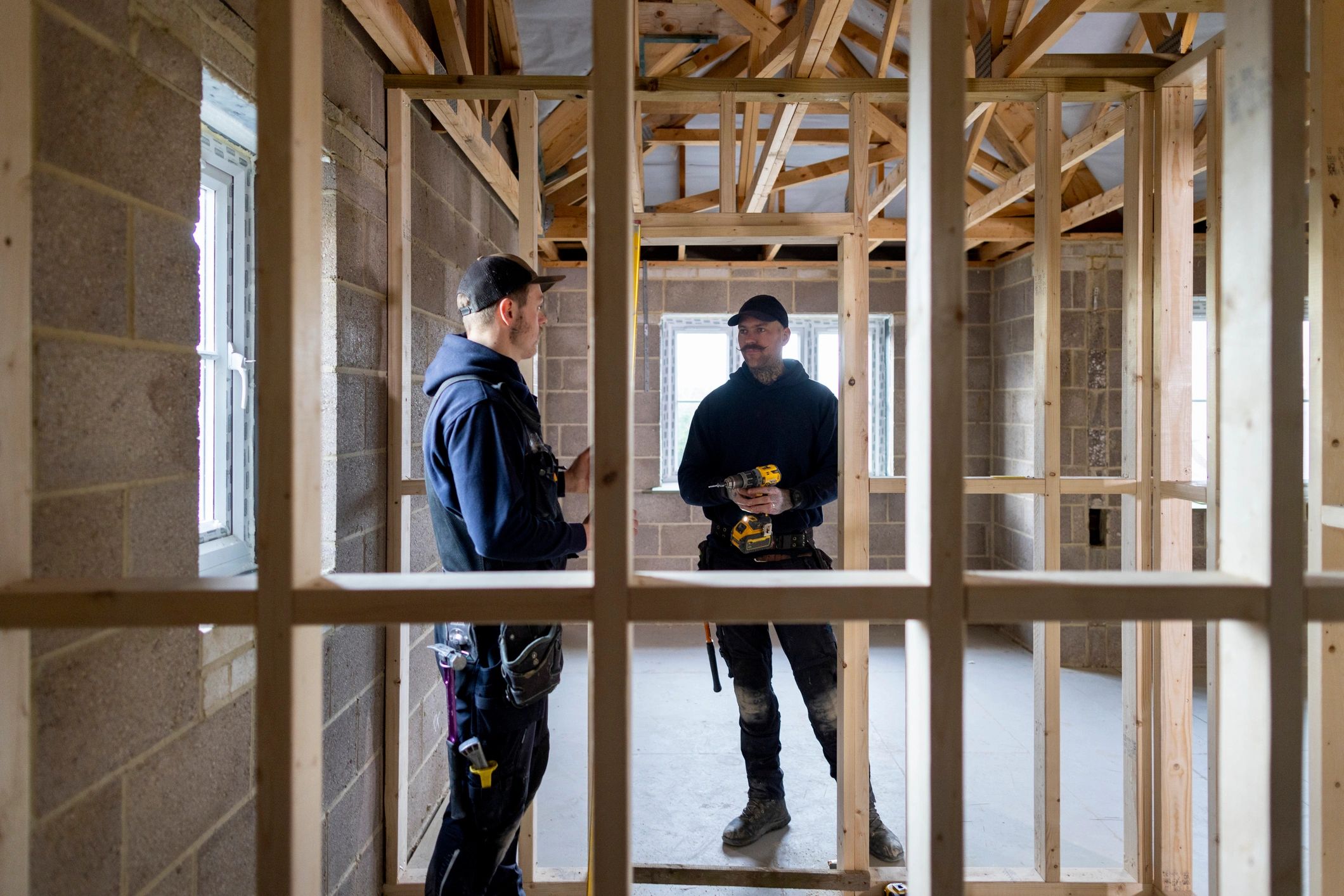 Two restoration professionals discussing a property project on site